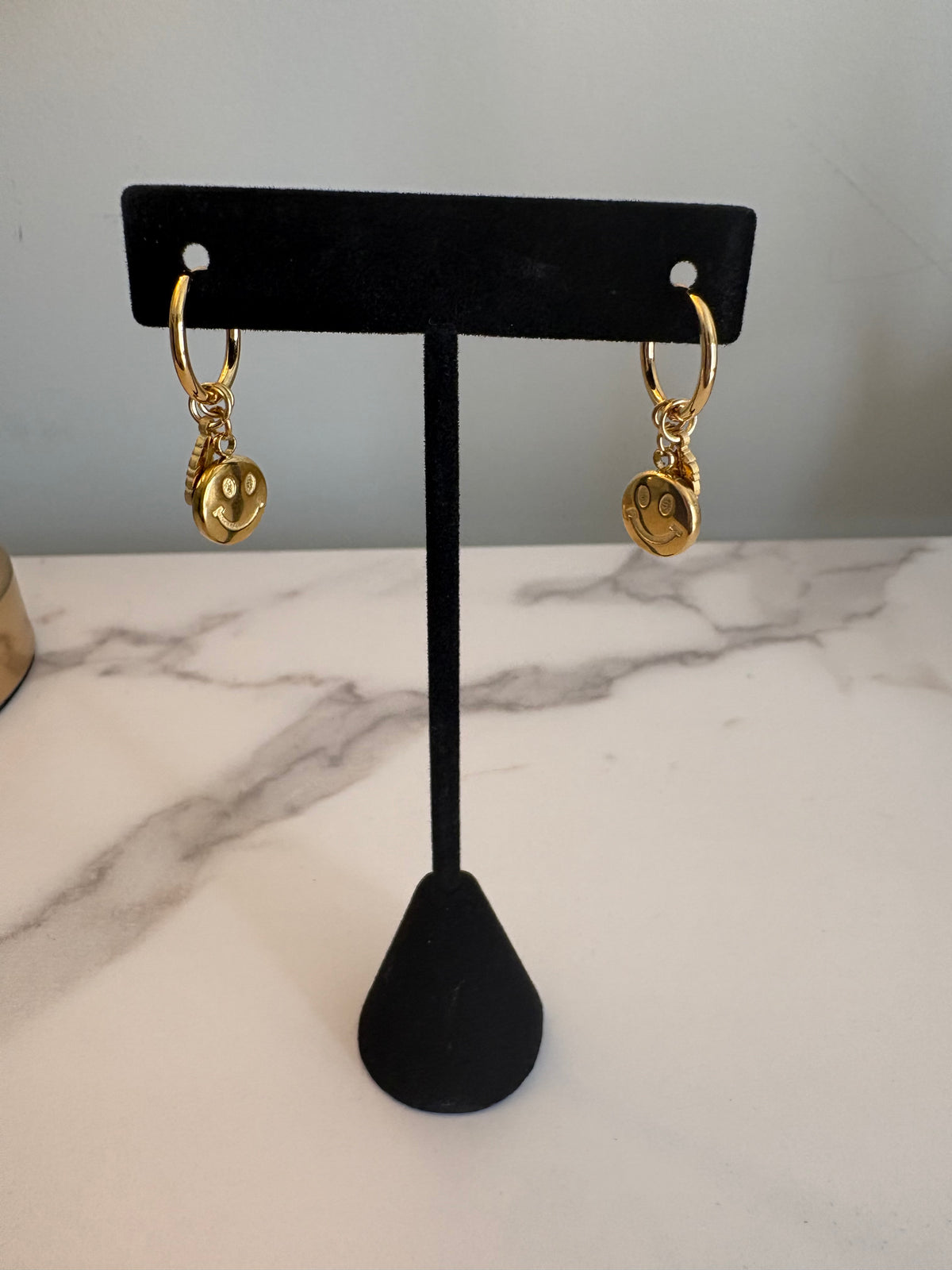 Gold smiley/feather earrings