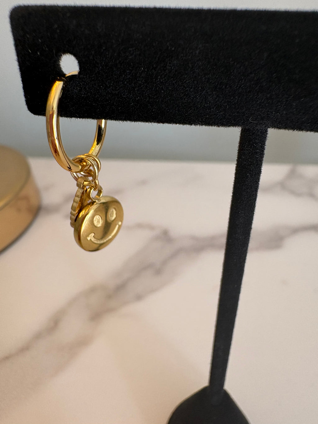 Gold smiley/feather earrings